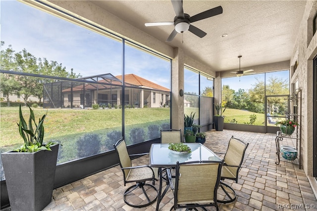 sunroom with ceiling fan