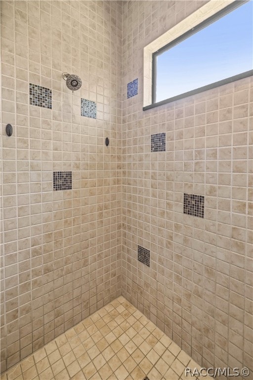 bathroom with a tile shower