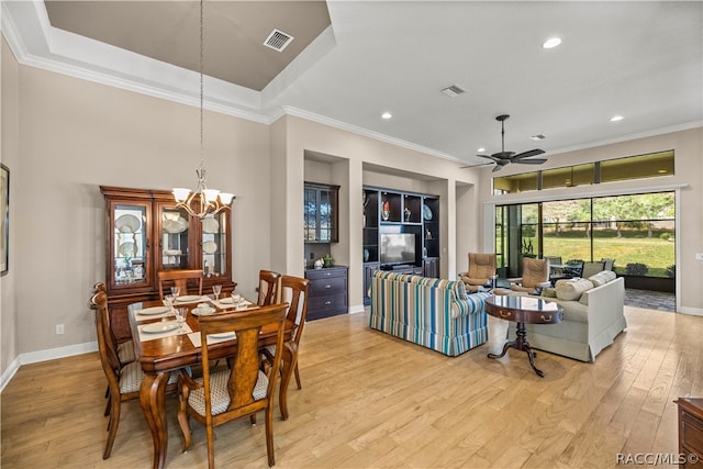 dining space with ceiling fan with notable chandelier, light hardwood / wood-style floors, and crown molding