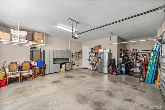 garage featuring stainless steel fridge and a garage door opener