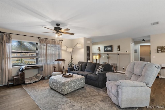 living room featuring hardwood / wood-style floors and ceiling fan