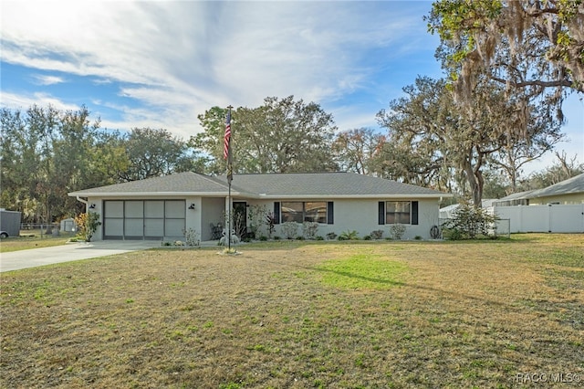 ranch-style house featuring a garage and a front lawn