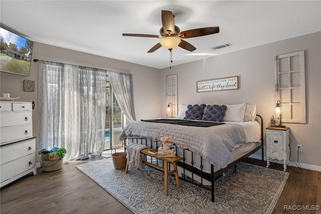 bedroom featuring access to exterior, dark wood-type flooring, and ceiling fan