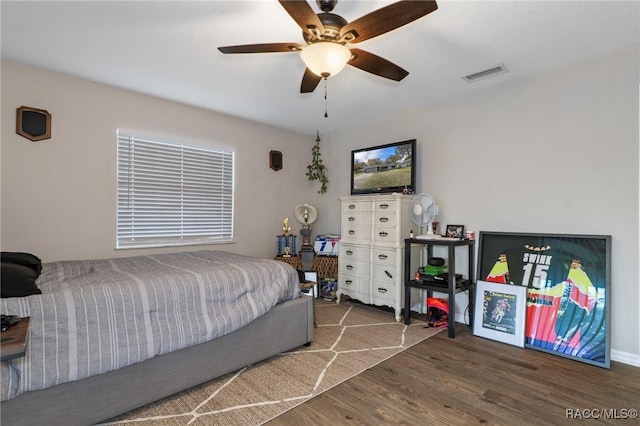 bedroom with ceiling fan and dark hardwood / wood-style floors