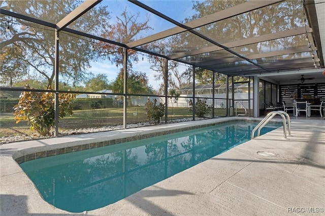 view of swimming pool featuring a lanai and a patio area