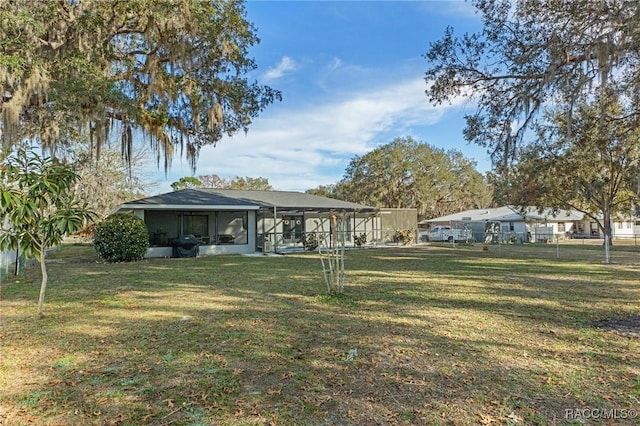 view of yard with a sunroom and a lanai