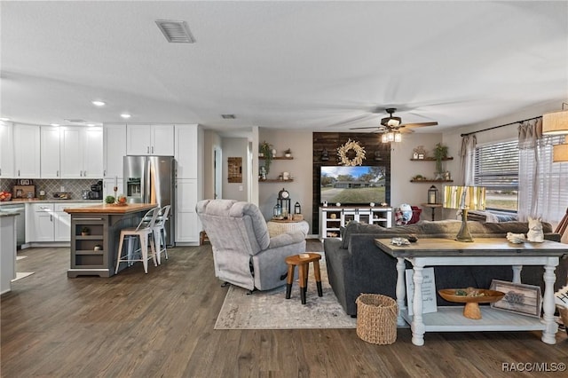 living room featuring dark hardwood / wood-style floors and ceiling fan