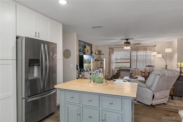 kitchen with wood counters, white cabinetry, wood-type flooring, stainless steel fridge with ice dispenser, and ceiling fan