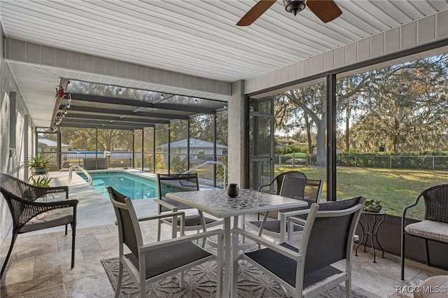 sunroom / solarium featuring plenty of natural light and ceiling fan