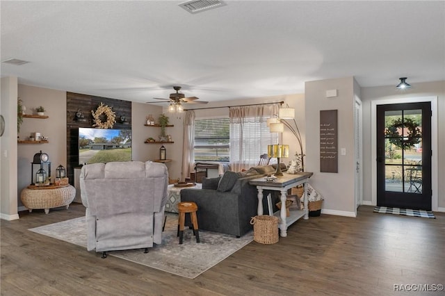 living room featuring plenty of natural light and dark hardwood / wood-style flooring