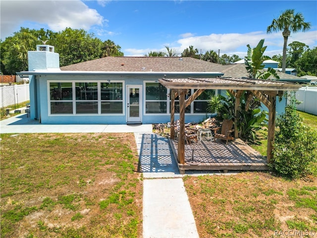 rear view of house featuring a patio area and a yard