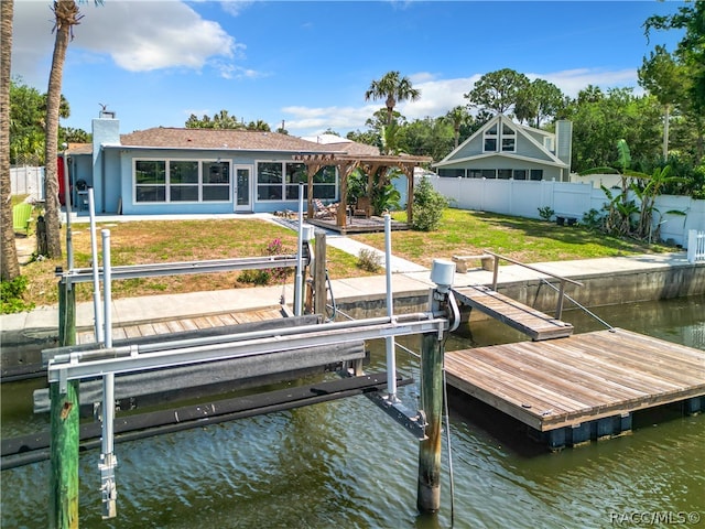 dock area with a yard and a water view