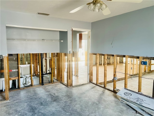 interior space with ceiling fan and concrete floors