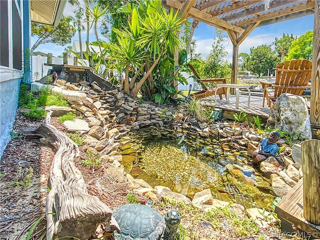 view of yard with a deck and a pergola