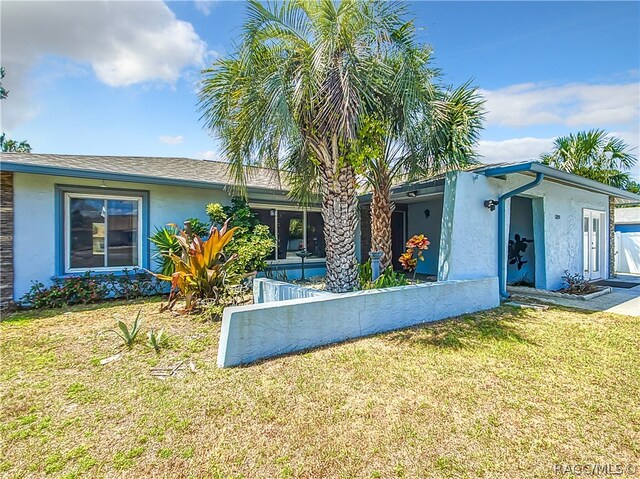 ranch-style house with a front lawn