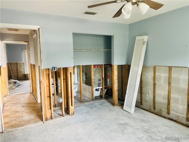 interior space with ceiling fan and concrete flooring