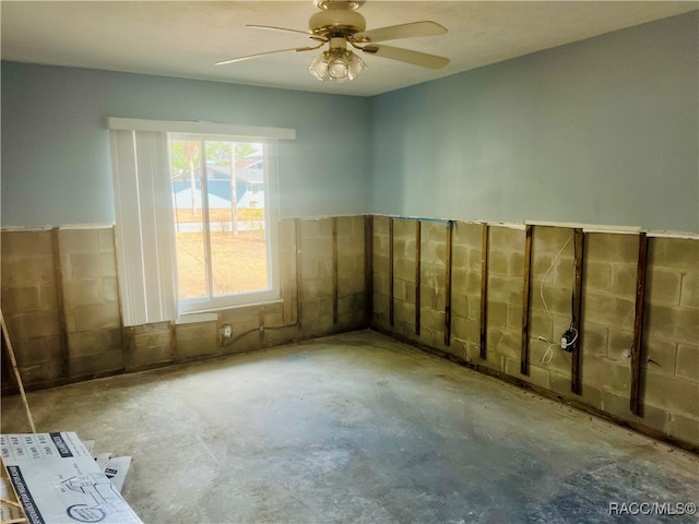 empty room with concrete floors and ceiling fan