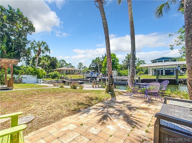 view of patio / terrace featuring a boat dock and a water view