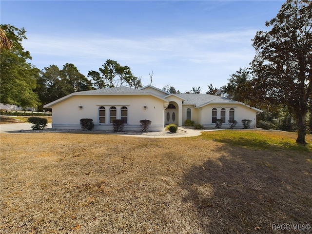 ranch-style house with a front lawn