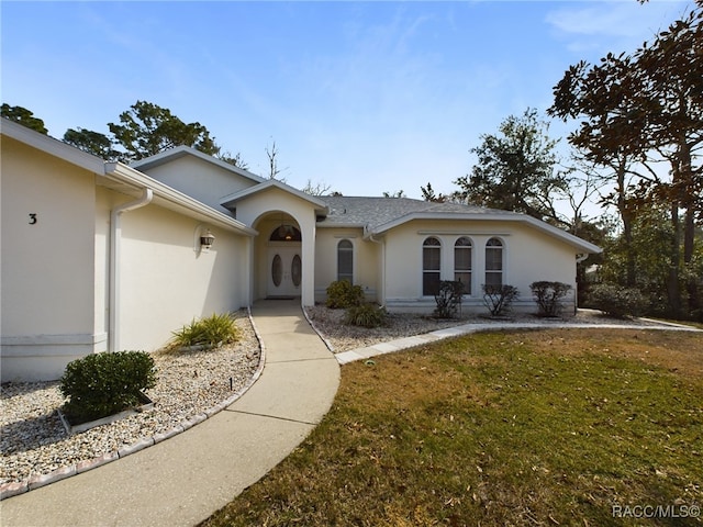 ranch-style home with a front yard