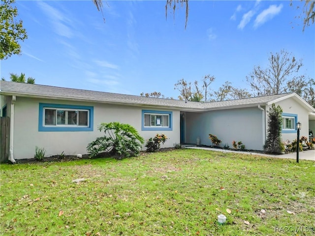 ranch-style home featuring a front lawn