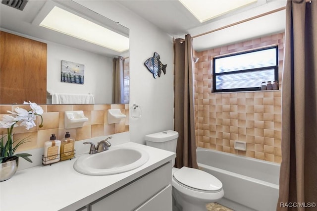 full bathroom featuring toilet, vanity, and shower / bath combination with curtain