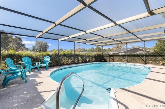 view of swimming pool featuring a lanai and a patio area