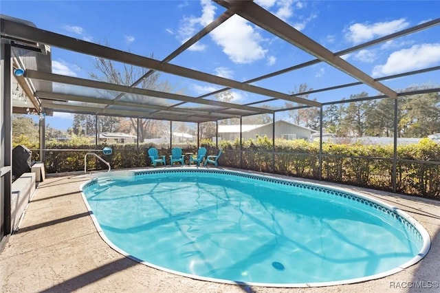 view of swimming pool featuring a lanai and a patio area