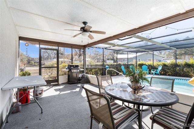 sunroom / solarium featuring ceiling fan