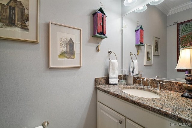 bathroom featuring crown molding and vanity