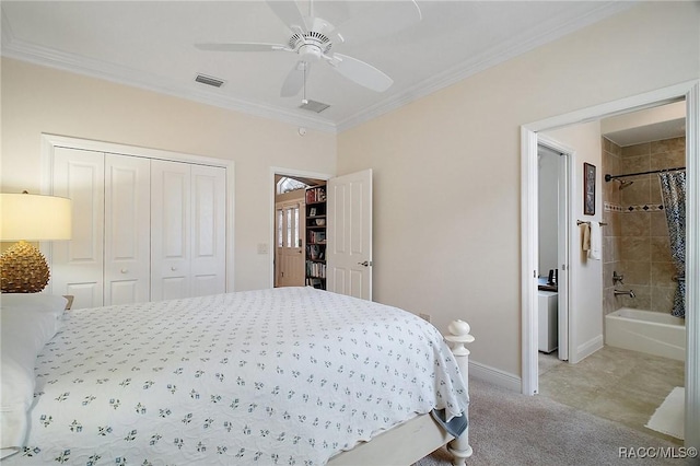 bedroom with visible vents, crown molding, a closet, baseboards, and connected bathroom