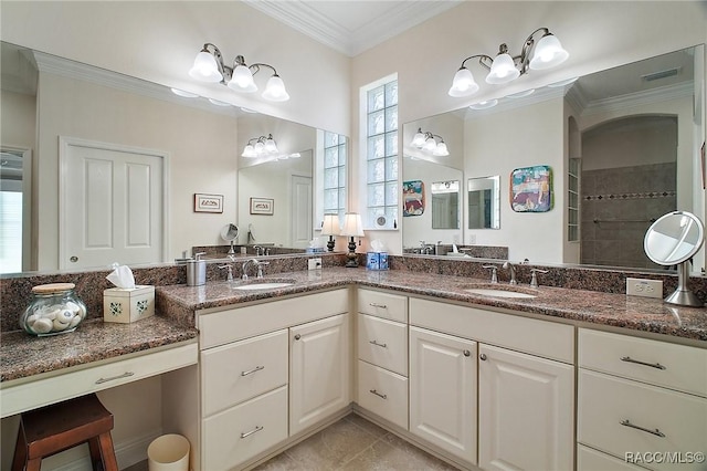 full bathroom with double vanity, visible vents, ornamental molding, and a sink