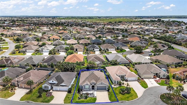 bird's eye view featuring a water view and a residential view