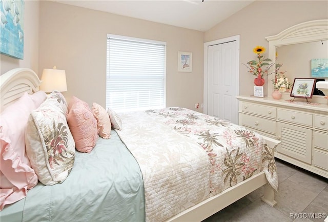 2101 N Brentwood Cir, Lecanto, FL 34461 - bedroom featuring lofted ceiling, tile patterned floors, and a closet