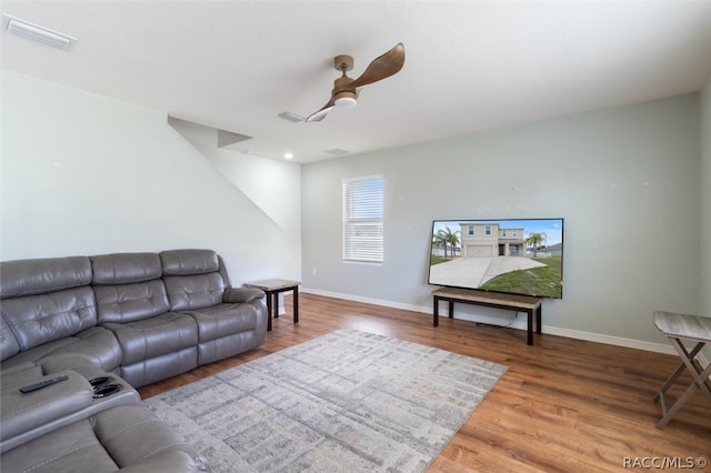 living room featuring ceiling fan and wood-type flooring