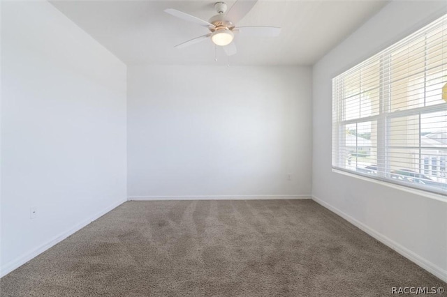 unfurnished room with carpet, baseboards, and ceiling fan