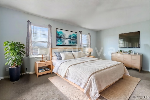 bedroom featuring dark colored carpet and baseboards