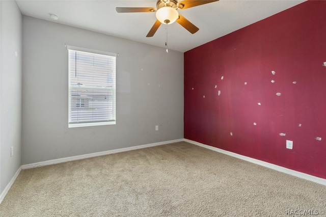 spare room with carpet floors and ceiling fan