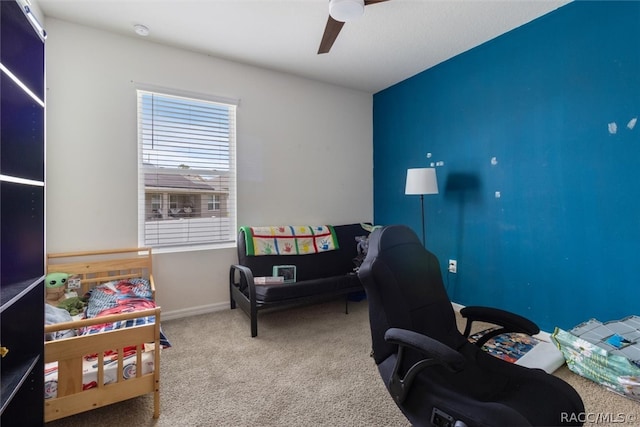 carpeted home office featuring ceiling fan