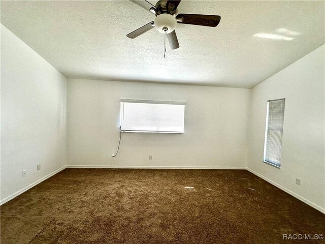 3150 W Mustang Blvd, Beverly Hills, FL 34465 - empty room featuring carpet flooring, a textured ceiling, a ceiling fan, and baseboards
