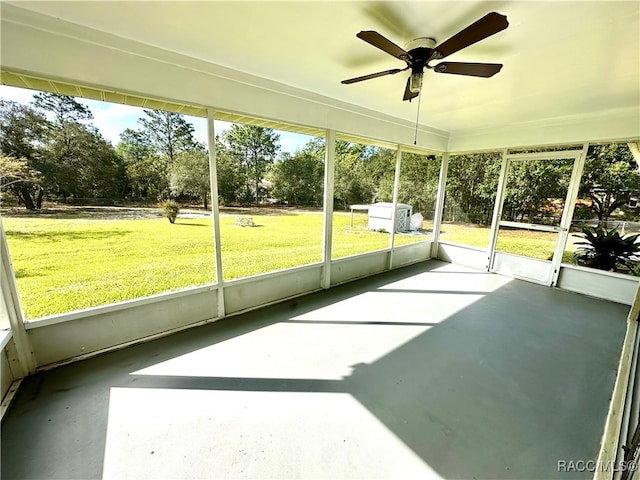 unfurnished sunroom with a wealth of natural light and ceiling fan