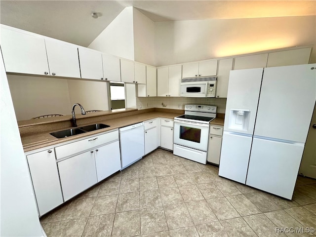 kitchen with white appliances, high vaulted ceiling, white cabinets, sink, and light tile patterned floors