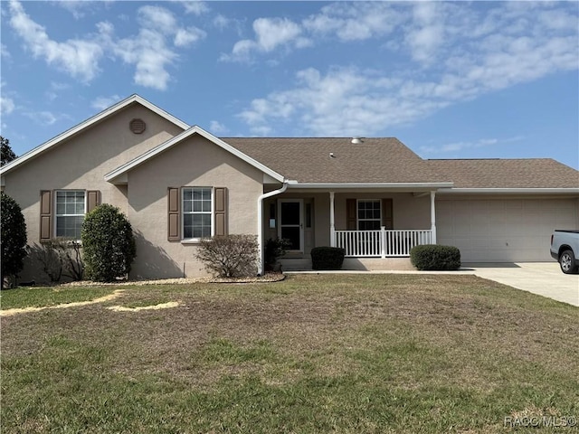 single story home featuring a garage, a front yard, and covered porch