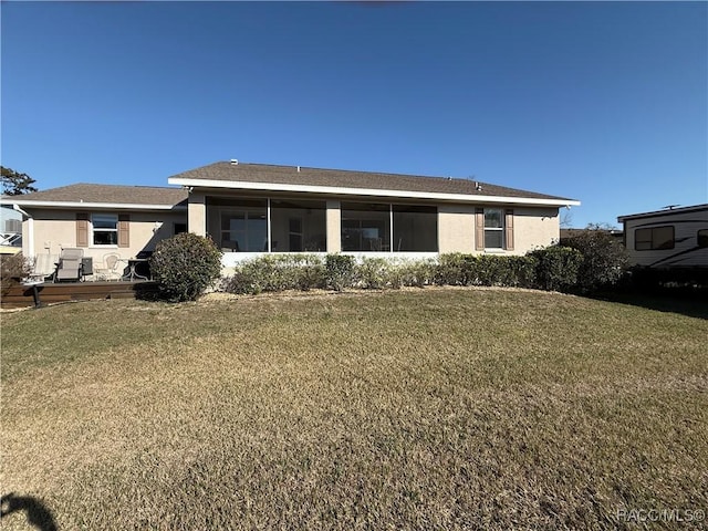 back of house with a wooden deck and a lawn