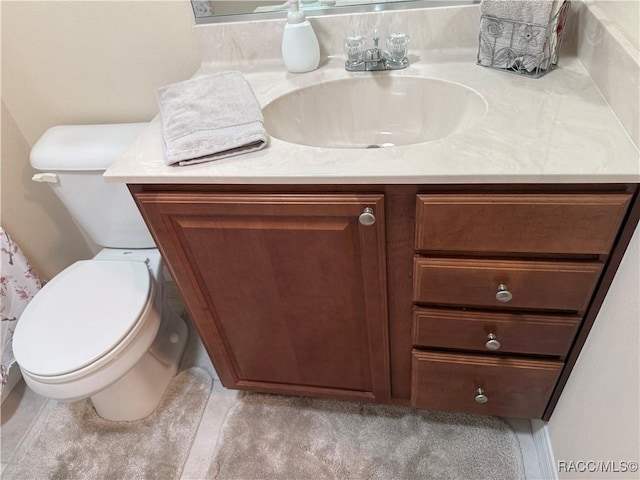 bathroom featuring vanity and toilet