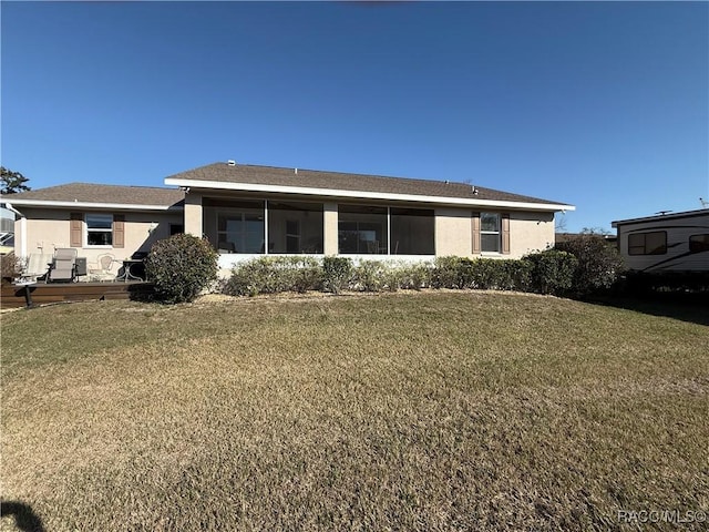 3926 N Eagle Pt, Crystal River, FL 34428 - back of house featuring a lawn, stucco siding, and a sunroom