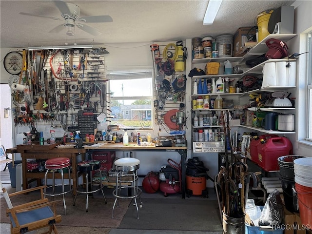 interior space with ceiling fan