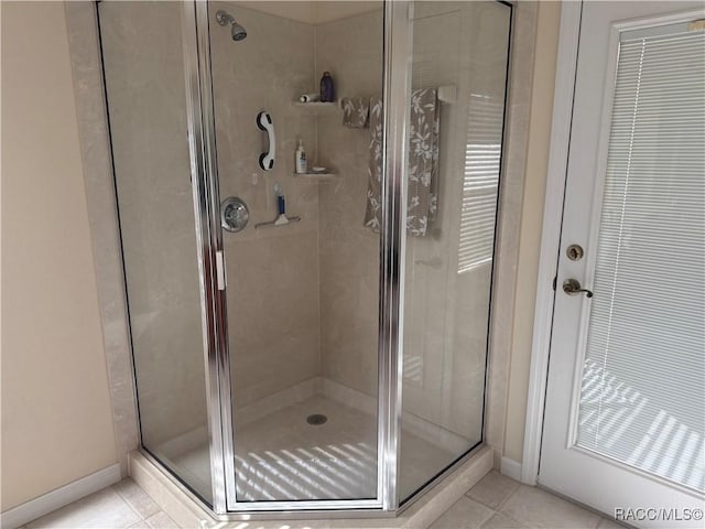 bathroom featuring tile patterned flooring and a shower with door