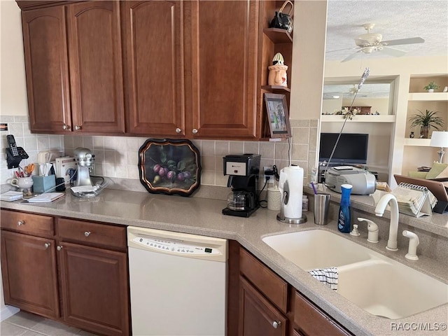 kitchen featuring sink, dishwasher, ceiling fan, a textured ceiling, and decorative backsplash