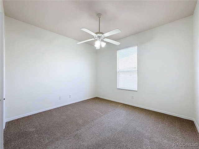 carpeted empty room featuring ceiling fan